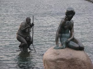 Rich world sits atop starving African man, sculpture at Copenhagen